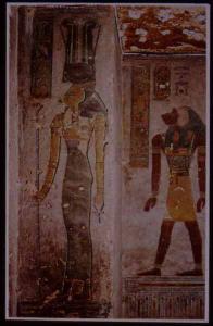Hathor, "mistress of the west," in the tomb of Rameses III, in a relatively rare represenation with the head of a cow and two tall ostrich feathers, along with the cow horns and sun disk more usual to this goddess.  In the background is the monkey-headed